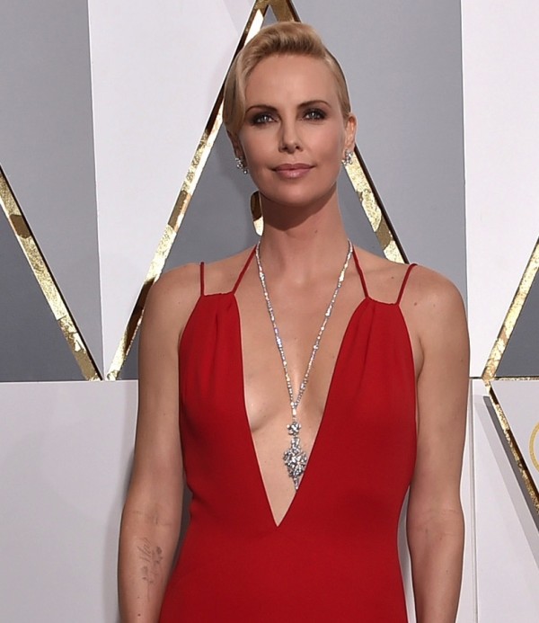 Charlize Theron in ultra long diamond necklace and diamond earrings