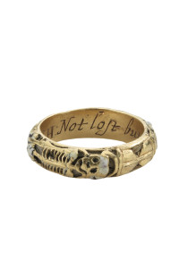 From the Benjamin Zucker "Cycles of Life" collection  Memorial and Memento Mori Ring. This gold hoop ring is enameled black outside with a white skeleton, a skull, an hourglass, skull and crossed bones, a snake, a crossed pick and shovel; it isinscribed within WH Nov. 18 1661 NOT LOST BUT GONE BEFORE. Alock of the deceased’s hair is inside the hoop. Dated 1661